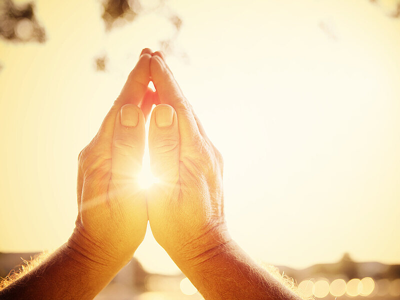 praying hands, rising sun