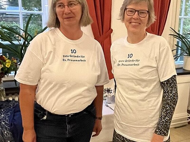 Two women in special woman empowerment t-shirts