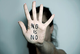 women showing hand with note no is no