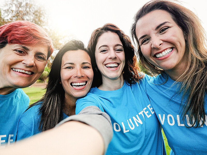 Happy group of volunteer people taking selfie